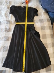 Vintage Black Dress No Tags. Has Shoulder Pads and a Bow on the Side. Rayon