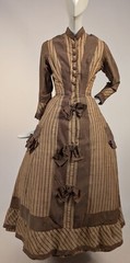 LATE 1860’S PINSTRIPED TAN BOMBAZINE DRESS W BOWS + SIDE POCKET DETAIL