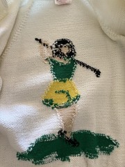 Vintage 1950s hand-knit cardigan. Features a female golfer and ball. Kitchey